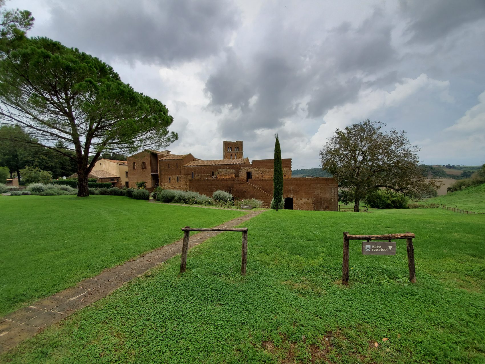 The abbey and its grounds under a stormy sky.