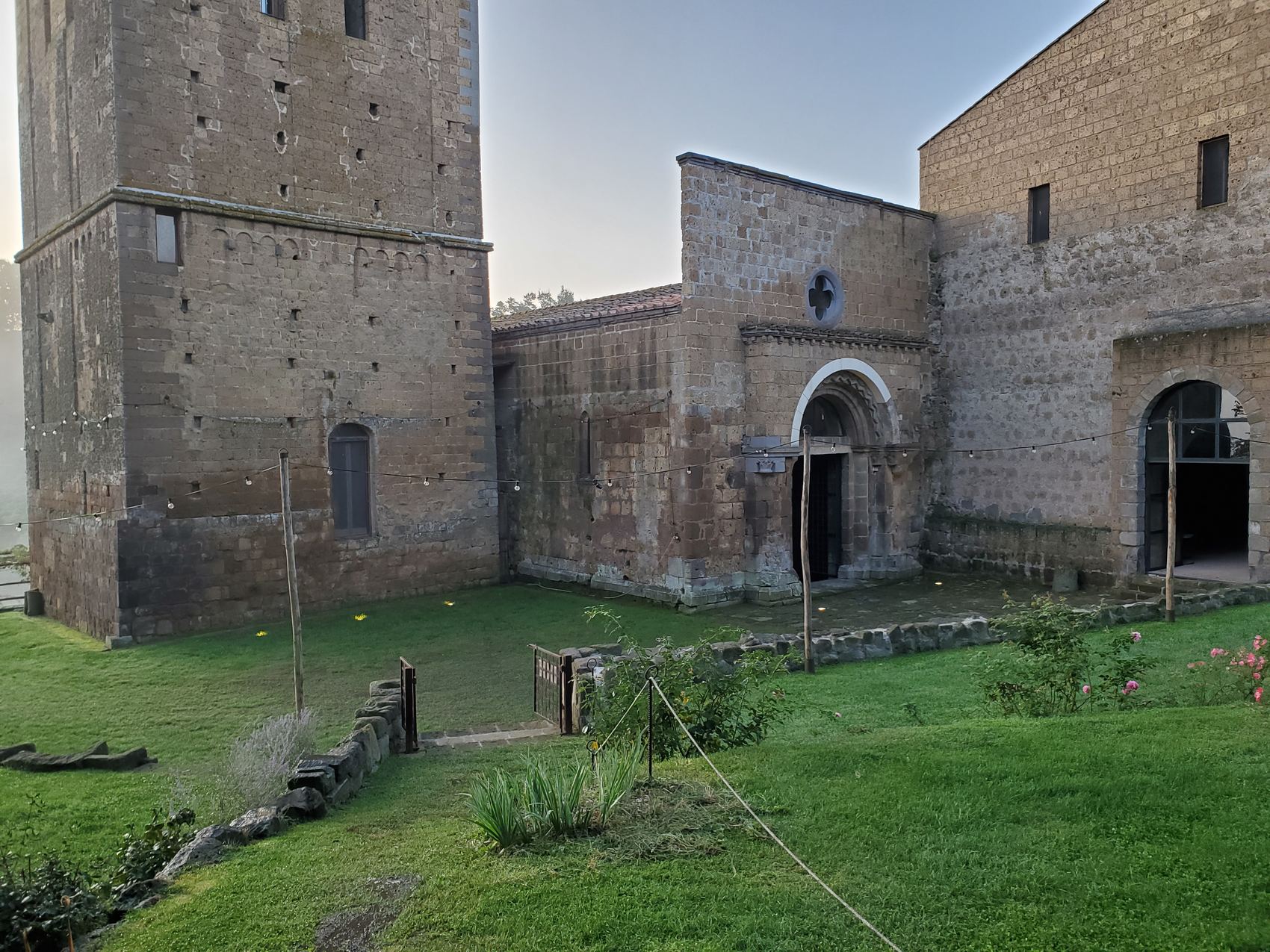 The abbey courtyard and bell tower at dawn.