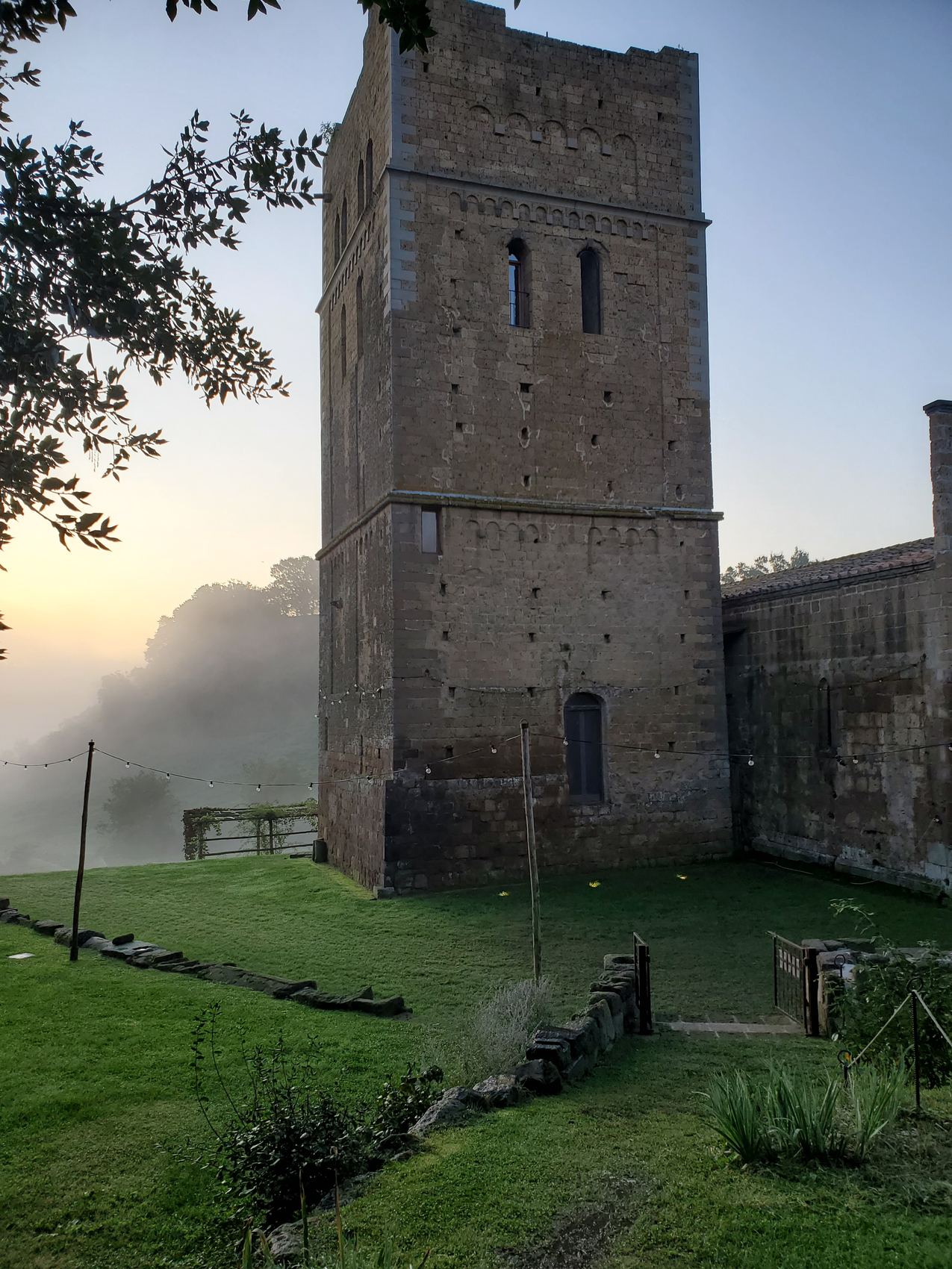 The abbey bell tower rising out of the morning mist.